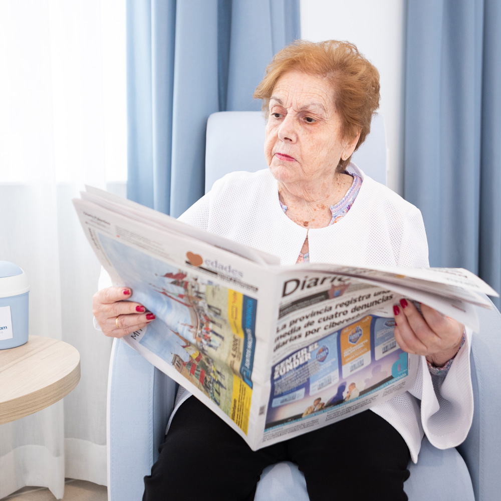 Una residente leyendo un periódico